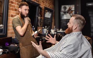 Photo of a barber talking the client in his chair