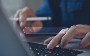 Photo of a person working on a laptop with a search box looking to advertise jobs online